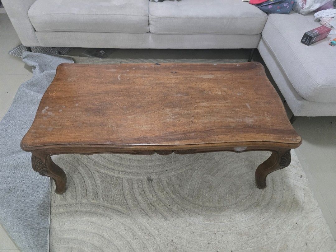 Narra coffee table with ornate legs (Category: Tables & Sets) located in Manila. Submitted by ezehzzyboy (Listing ID 1447835884, Image 1). Description: - Beautiful wooden coffee table with a warm brown tone. - Features elegant curved edges and ornate carved legs. - Perfect size for your living room. - Shows minor surface wear, adding to its character. - Ready to be the centerpiece of your space!.