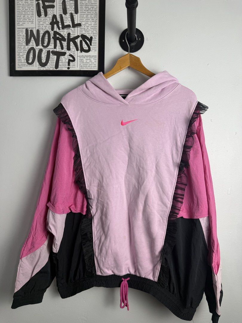 Nike Pink Black Hoodie (Category: Activewear) located in Manila. Submitted by wornagainstudios2 (Listing ID 1447691199, Image 1). Description: - Eye-catching Nike hoodie with pink and black color blocking. - Features unique sheer ruffle details on the sides and sleeves. - Adjustable drawstring hem for a customized fit. - Bold "big swoosh" logo prominently displayed on the back. - Perfect for creating a distinctive streetwear aesthetic. -perfect c