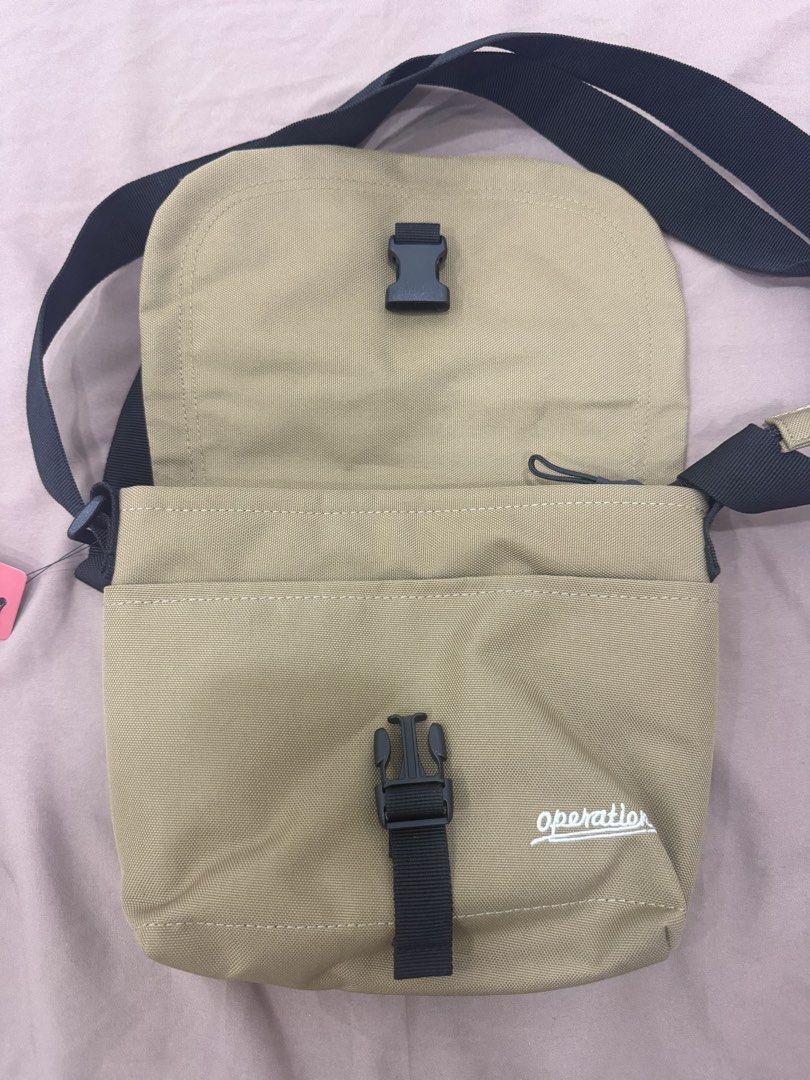 Operations Khaki Canvas Crossbody Bag (Category: Cross-body Bags) located in Quezon City. Submitted by _cmls (Listing ID 1447820498, Image 3). Description: - Khaki canvas crossbody bag from Operations - Main zip compartment - Front zip pocket - Adjustable strap - Buckle closure on flap - Back zip pocket for extra storage - Ideal for everyday use.