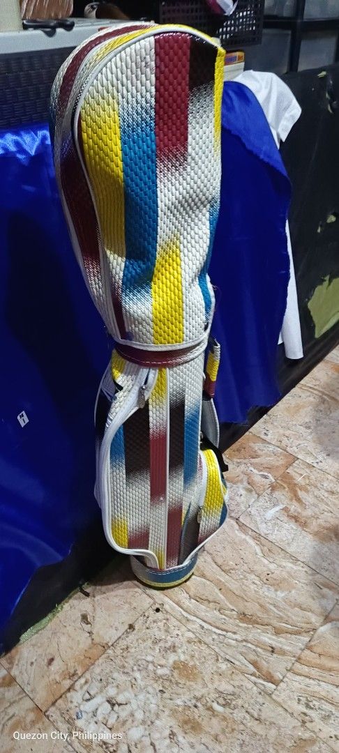 PGM Colorful Golf Bag with Unique Striped Pattern (Category: Golf) located in Manila. Submitted by yeonmei5614747 (Listing ID 1447882986, Image 1). Description: - Unique, eye-catching abstract striped design (yellow, red, blue, white) - Ample storage for clubs and golf gear - Built for durability - Ready to hit the golf course -As Is.
