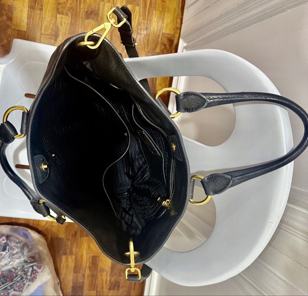 Prada Black Leather Tote Bag with Gold Hardware scratch proof (Category: Luxury Bags & Wallets) located in Quezon City. Submitted by olxph_441031685 (Listing ID 1447713930, Image 2). Description: - Authentic Prada Black Leather Tote Bag - Pebbled leather exterior - Gold-tone hardware - Spacious interior with multiple compartments - Interior zippered pocket - Top handles - Detachable shoulder strap - Classic Prada logo on front - Versatile for dai