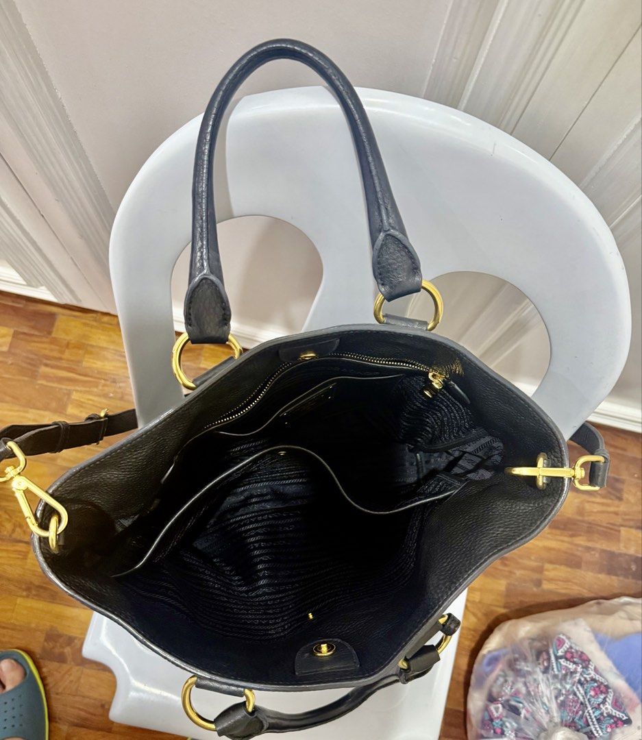 Prada Black Leather Tote Bag with Gold Hardware scratch proof (Category: Luxury Bags & Wallets) located in Quezon City. Submitted by olxph_441031685 (Listing ID 1447713930, Image 1). Description: - Authentic Prada Black Leather Tote Bag - Pebbled leather exterior - Gold-tone hardware - Spacious interior with multiple compartments - Interior zippered pocket - Top handles - Detachable shoulder strap - Classic Prada logo on front - Versatile for dai