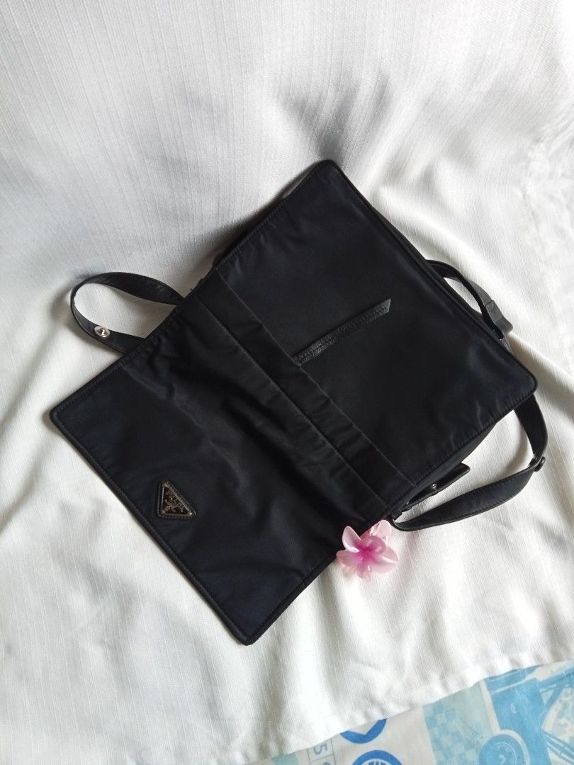 Prada black nylon padded shoulder bag (Category: Luxury Bags & Wallets) located in Bagabag. Submitted by thrift_stories96 (Listing ID 1447835426, Image 2). Description: Prada black nylon padded shoulder bag 2 way pwede din maging kili bag adjustable strap Medium size Measurements Height - 9.5 Width - 12 Condition - Rank AB Flaw - minimal rubs sa lining Clean interior and exterior cloth.