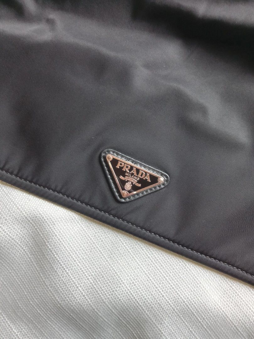 Prada black nylon padded shoulder bag (Category: Luxury Bags & Wallets) located in Bagabag. Submitted by thrift_stories96 (Listing ID 1447835426, Image 3). Description: Prada black nylon padded shoulder bag 2 way pwede din maging kili bag adjustable strap Medium size Measurements Height - 9.5 Width - 12 Condition - Rank AB Flaw - minimal rubs sa lining Clean interior and exterior cloth.