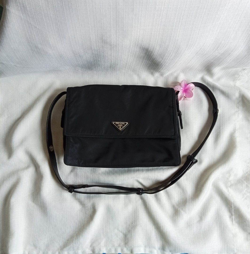 Prada black nylon padded shoulder bag (Category: Luxury Bags & Wallets) located in Bagabag. Submitted by thrift_stories96 (Listing ID 1447835426, Image 1). Description: Prada black nylon padded shoulder bag 2 way pwede din maging kili bag adjustable strap Medium size Measurements Height - 9.5 Width - 12 Condition - Rank AB Flaw - minimal rubs sa lining Clean interior and exterior cloth.