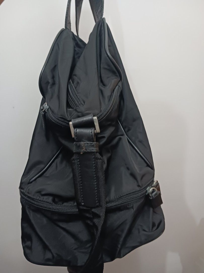 Prada Black Nylon Tote Travelling Bag (Category: Luxury Bags & Wallets) located in Koronadal. Submitted by milagraciaukayukay123_. (Listing ID 1447694674, Image 3). Description: - Authentic Prada bag -Super black nylon in actual ,money back if faded -Duffle bag for gym or travelling - Black nylon material with leather trim - Main zip compartment - Exterior pockets - Interior tag with number 146 - Ideal for everyday use or travel - Shows some sign