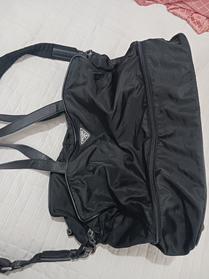 Prada Black Nylon Tote Travelling Bag (Category: Luxury Bags & Wallets) located in Koronadal. Submitted by milagraciaukayukay123_. (Listing ID 1447694674, Image 2). Description: - Authentic Prada bag -Super black nylon in actual ,money back if faded -Duffle bag for gym or travelling - Black nylon material with leather trim - Main zip compartment - Exterior pockets - Interior tag with number 146 - Ideal for everyday use or travel - Shows some sign