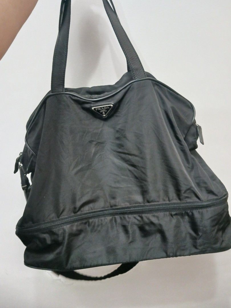 Prada Black Nylon Tote Travelling Bag (Category: Luxury Bags & Wallets) located in Koronadal. Submitted by milagraciaukayukay123_. (Listing ID 1447694674, Image 1). Description: - Authentic Prada bag -Super black nylon in actual ,money back if faded -Duffle bag for gym or travelling - Black nylon material with leather trim - Main zip compartment - Exterior pockets - Interior tag with number 146 - Ideal for everyday use or travel - Shows some sign