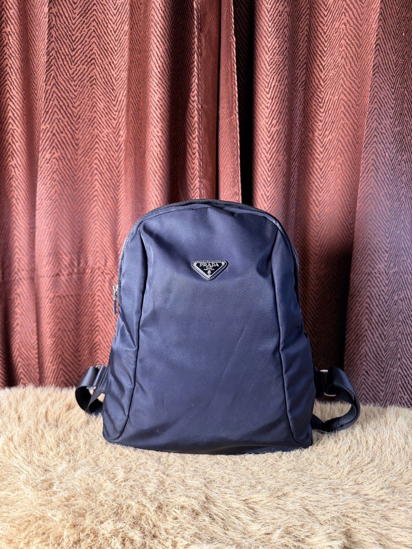 Prada Nylon Backpack Navy Blue (Category: Luxury Bags & Wallets) located in Manila. Submitted by femnlofficial (Listing ID 1447881701, Image 1). Description: - Classic Prada backpack - Navy blue durable nylon material - Adjustable shoulder straps and top handle - Front zip pocket for easy access - Spacious interior for essentials - Ideal for daily use or travel.