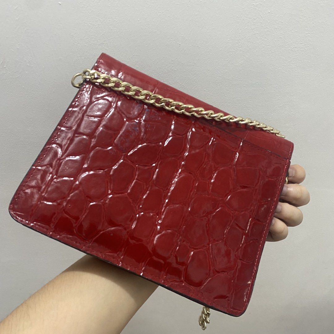 Red Croc Embossed Chain Shoulder Bag (Category: Shoulder Bags) located in Caloocan City. Submitted by _syddd (Listing ID 1447744247, Image 3). Description: - Eye-catching red shoulder bag - Luxurious croc-embossed texture - Elegant gold chain strap - Stylish ring detail on the front flap - Convenient interior zipped pocket - Proudly made in Korea - Fits a small wallet, ideal for essentials.