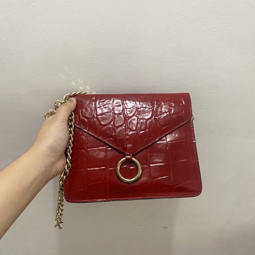 Red Croc Embossed Chain Shoulder Bag (Category: Shoulder Bags) located in Caloocan City. Submitted by _syddd (Listing ID 1447744247, Image 2). Description: - Eye-catching red shoulder bag - Luxurious croc-embossed texture - Elegant gold chain strap - Stylish ring detail on the front flap - Convenient interior zipped pocket - Proudly made in Korea - Fits a small wallet, ideal for essentials.