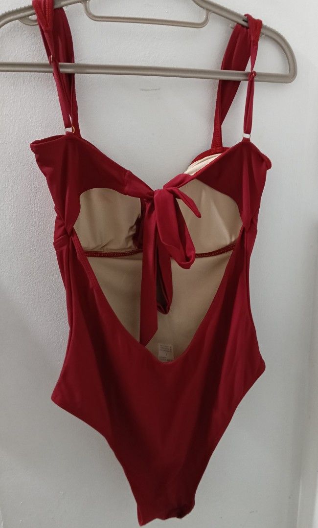 Red One-Piece Swimsuit with Tie Back (Category: Bikinis & Swimsuits) located in Quezon City. Submitted by annermt (Listing ID 1447798431, Image 3). Description: - Deep red one-piece swimsuit - Adjustable straps for a perfect fit - Secure tie-back closure - Two elegant gold-toned buttons on the front - Light beige lining - Ideal for beach and pool days rfs: sized down.