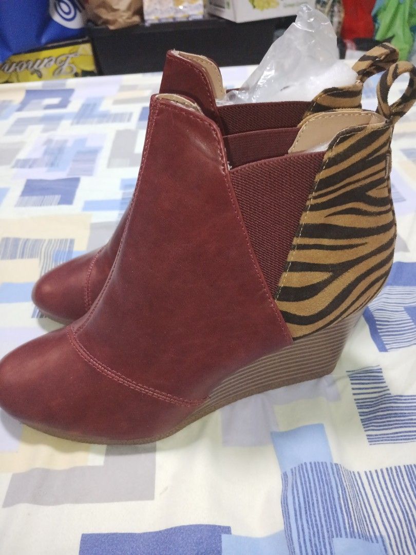 Red Wedge Ankle Boots with Tiger Print Accent Size 8 (Category: Boots) located in Manila. Submitted by misstoni28 (Listing ID 1447713258, Image 2). Description: - Size 8 -8.5 womens - Eye-catching red ankle boots - Comfortable wedge heel - Stretchy side panel for easy wear - Unique tiger print detail at the back - Effortless slip-on design - Versatile: dress up or down - Stylish and comfortable for all-day wear.