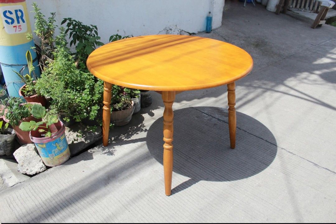 Round Dining Table (Category: Tables & Sets) located in Meycauayan. Submitted by marygracecasimiro (Listing ID 1447879885, Image 3). Description: Solid Wood Round Dining Table Classic round solid wood dining table with a smooth polished top and traditional turned wooden legs. Finished in a warm honey-amber tone that highlights the natural wood grain, it offers a timeless rustic look. Sturdy and elegant L:40 ¼ • W:40 ¼ • H:28 inches 8,800 pesos on