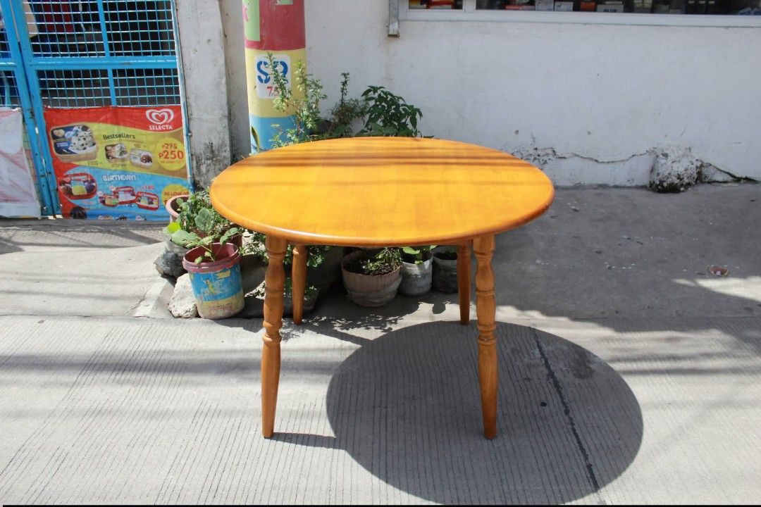 Round Dining Table (Category: Tables & Sets) located in Meycauayan. Submitted by marygracecasimiro (Listing ID 1447879885, Image 1). Description: Solid Wood Round Dining Table Classic round solid wood dining table with a smooth polished top and traditional turned wooden legs. Finished in a warm honey-amber tone that highlights the natural wood grain, it offers a timeless rustic look. Sturdy and elegant L:40 ¼ • W:40 ¼ • H:28 inches 8,800 pesos on