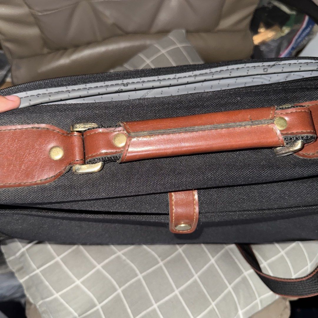 Samsonite Black Briefcase with Leather Accents (Category: Briefcases) located in Manila. Submitted by batoygonz19661 (Listing ID 1447750213, Image 3). Description: - Classic Samsonite black briefcase - Rich brown leather handles and trim - Multiple interior pockets for excellent organization - Subtle Samsonite patterned interior lining - Adjustable shoulder strap for comfortable carrying - Perfect for both work and travel - Shows some signs of we