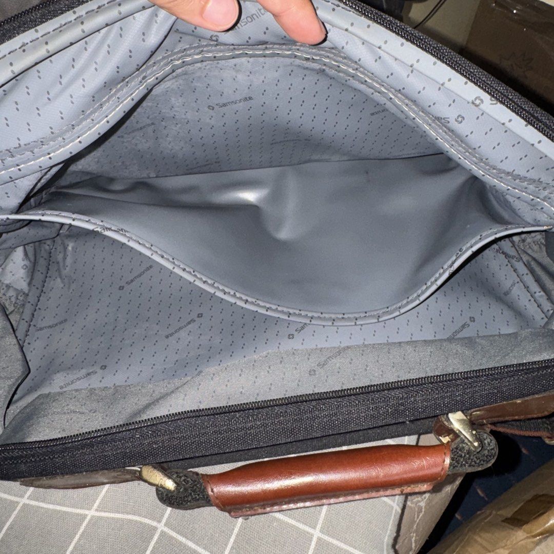Samsonite Black Briefcase with Leather Accents (Category: Briefcases) located in Manila. Submitted by batoygonz19661 (Listing ID 1447750213, Image 2). Description: - Classic Samsonite black briefcase - Rich brown leather handles and trim - Multiple interior pockets for excellent organization - Subtle Samsonite patterned interior lining - Adjustable shoulder strap for comfortable carrying - Perfect for both work and travel - Shows some signs of we