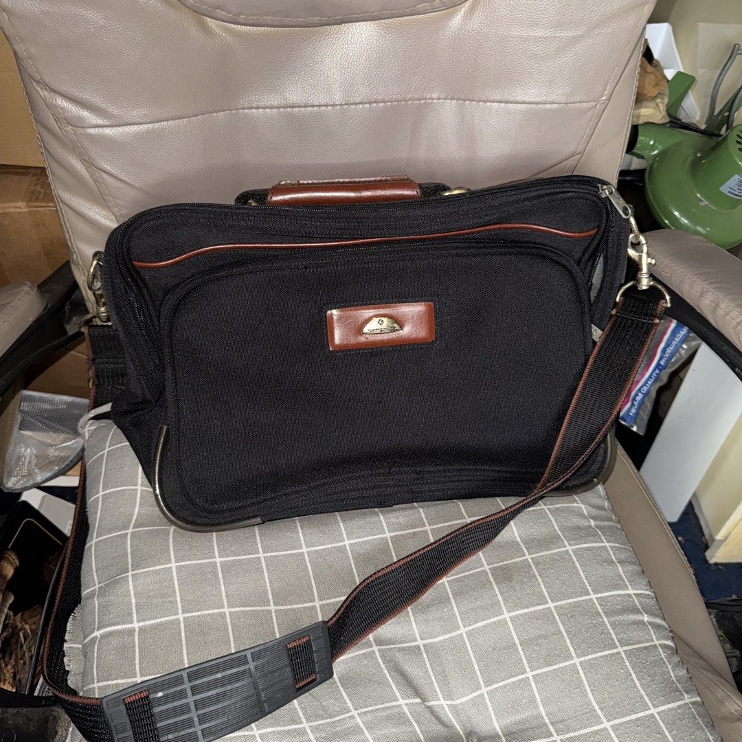 Samsonite Black Briefcase with Leather Accents (Category: Briefcases) located in Manila. Submitted by batoygonz19661 (Listing ID 1447750213, Image 1). Description: - Classic Samsonite black briefcase - Rich brown leather handles and trim - Multiple interior pockets for excellent organization - Subtle Samsonite patterned interior lining - Adjustable shoulder strap for comfortable carrying - Perfect for both work and travel - Shows some signs of we