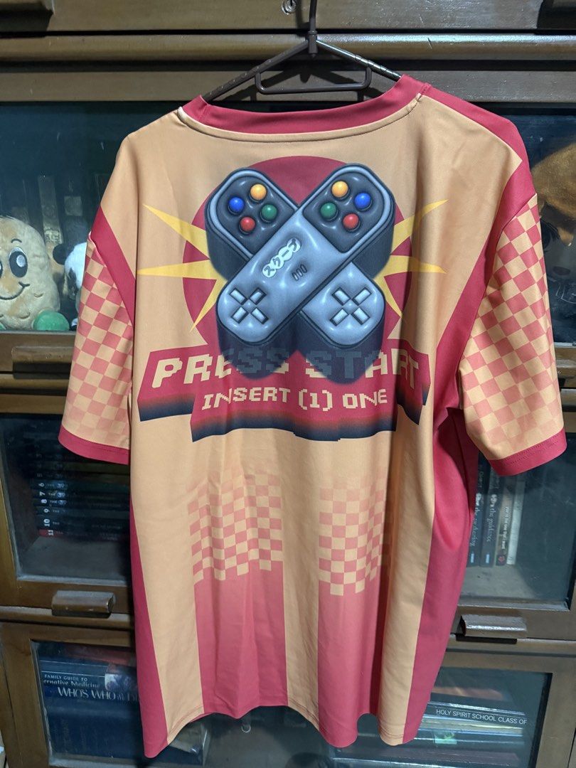 Skoop "Press Start" Shirt (Large) (Category: Tshirts & Polo Shirts ) located in Quezon City. Submitted by halpharagus (Listing ID 1447828475, Image 2). Description: - Skoop graphic tee - "Press Start" retro design with game controllers on back - Japanese text and pixel graphics on front - Ideal for casual wear and gaming nights.