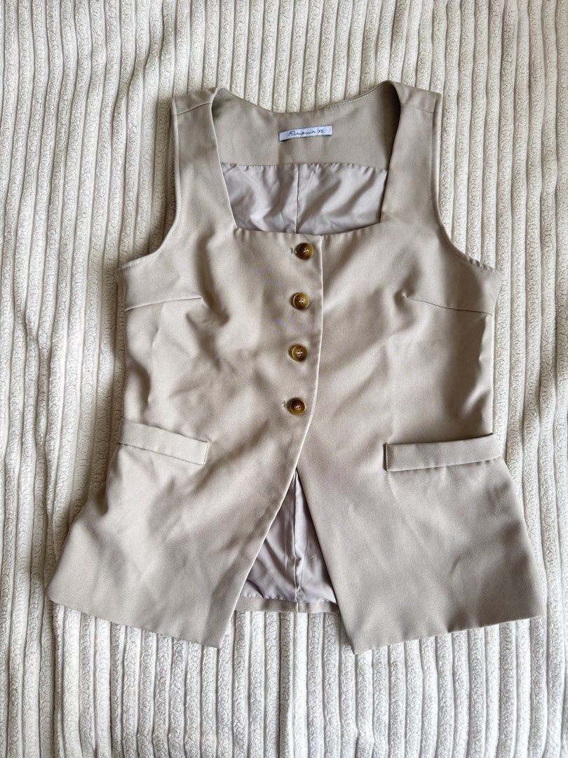 Sleeveless Square Neck Button-Up Vest Top - Khaki (Category: Sleeveless) located in Taguig. Submitted by _anythingpreloved (Listing ID 1447741370, Image 2). Description: - Sleeveless vest top - Square neckline - Button-up front - Two front pockets - Neutral khaki color - Easy to pair with any outfit - Perfect for layering or wearing alone - Ideal for a smart casual style.