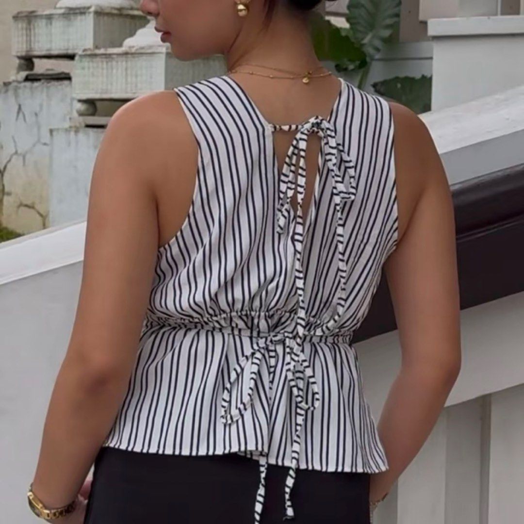 Striped V-Neck Sleeveless Top with Tie Back (Category: Sleeveless) located in Antipolo. Submitted by etoiles_ (Listing ID 1447756150, Image 2). Description: - Sleeveless top with classic black and white stripes. - Adjustable tie detail at the back to cinch the waist. - not yet worn!!.