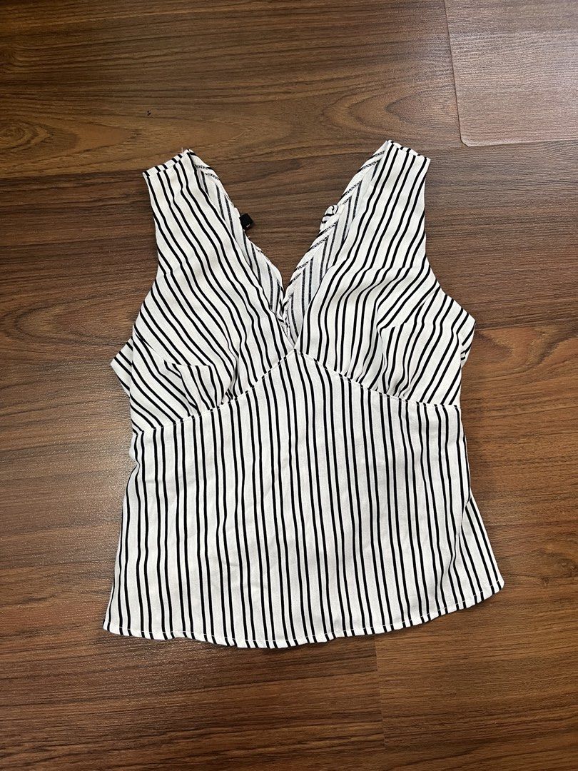 Striped V-Neck Sleeveless Top with Tie Back (Category: Sleeveless) located in Antipolo. Submitted by etoiles_ (Listing ID 1447756150, Image 3). Description: - Sleeveless top with classic black and white stripes. - Adjustable tie detail at the back to cinch the waist. - not yet worn!!.