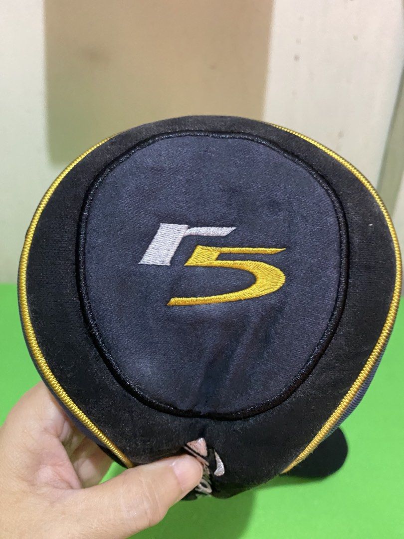 TaylorMade R5 Golf Driver Headcover (Category: Golf) located in Manila. Submitted by resi.diaz (Listing ID 1447729523, Image 2). Description: - Protect your TaylorMade R5 driver with this stylish headcover. - Features a classic black design with eye-catching yellow and blue accents. - Includes a stretchy black sock for a snug and secure fit. - Ideal for any TaylorMade enthusiast looking to keep their club safe..