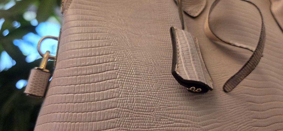 Genuine Leather Handbag with Long Sling (Alma type) (Category: Luxury Bags & Wallets) located in Manila. Submitted by amc88 (Listing ID 1447679023, Image 3). Description: - Elegant beige textured handbag - Structured base with protective gold feet - Secure top zipper closure - Stylish lock and key detail - Two comfortable top handles with extra sling - Detachable shoulder strap with gold buckle - Clean and spacious interior - Ideal for everyday w