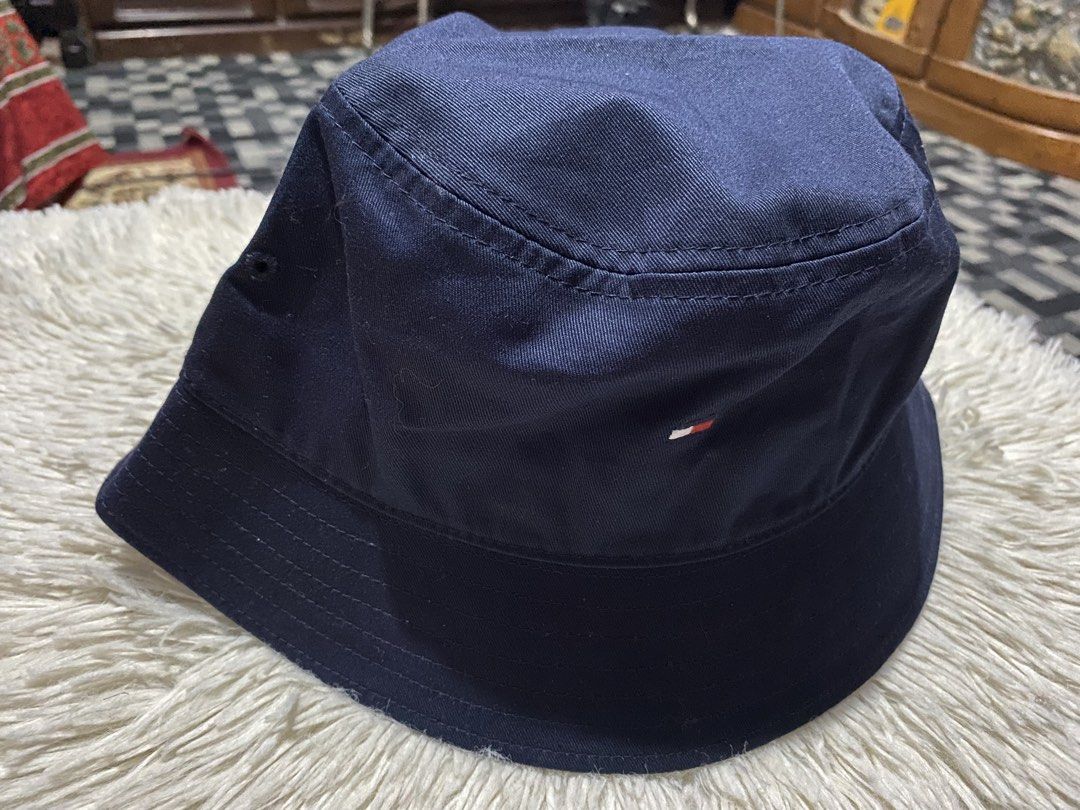 Tommy Hilfiger Navy Blue Bucket Hat OS (Category: Caps & Hats) located in Bulacan. Submitted by rich2545 (Listing ID 1447787922, Image 3). Description: - Navy blue Tommy Hilfiger bucket hat - Size: OS (One Size Fits Most) - Classic and simple design - Ideal for sunny days - Easy to pack and travel-friendly - Perfect for completing casual outfits.