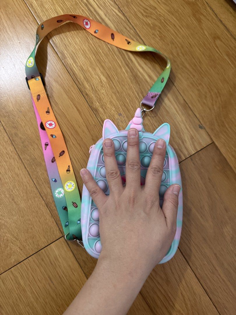 Unicorn Pop It Crossbody Bag with Rainbow Strap (Category: Babies & Kids Fashion) located in Mandaluyong City. Submitted by grmnk (Listing ID 1447712484, Image 2). Description: See photos for actual condition RFS: Too many bags BPI / GCash Pick-up from Hulo, Mandaluyong or GoGo Xpress.