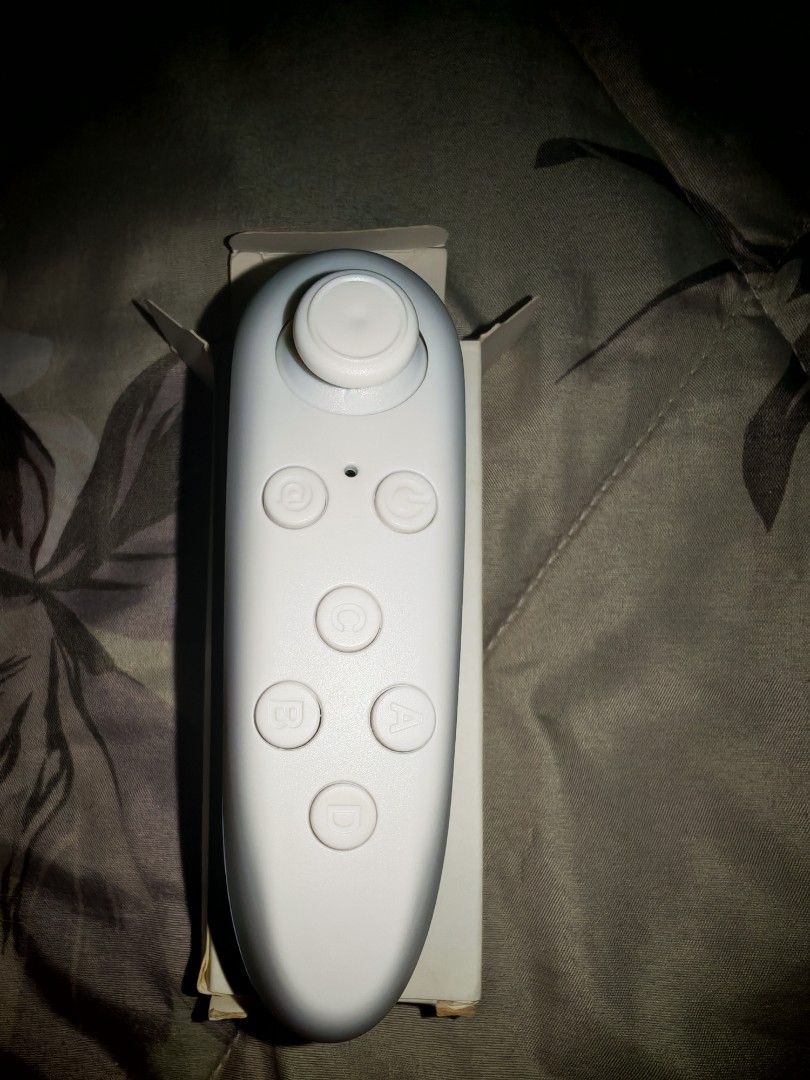 Universal Wireless Bluetooth Remote Controller for Android / iOS / VR (Category: Controllers) located in Kuala Lumpur. Submitted by PrinceK (Listing ID 1447723484, Image 1). Description: [NEW / BOXED] Universal Wireless Bluetooth Remote Controller Gamepad. Selling a completely clean, pristine white mini Bluetooth remote controller. Perfect for VR headsets (VR Box), mobile gaming, or acting as a wireless mouse/selfie shutter for your phone. Featur