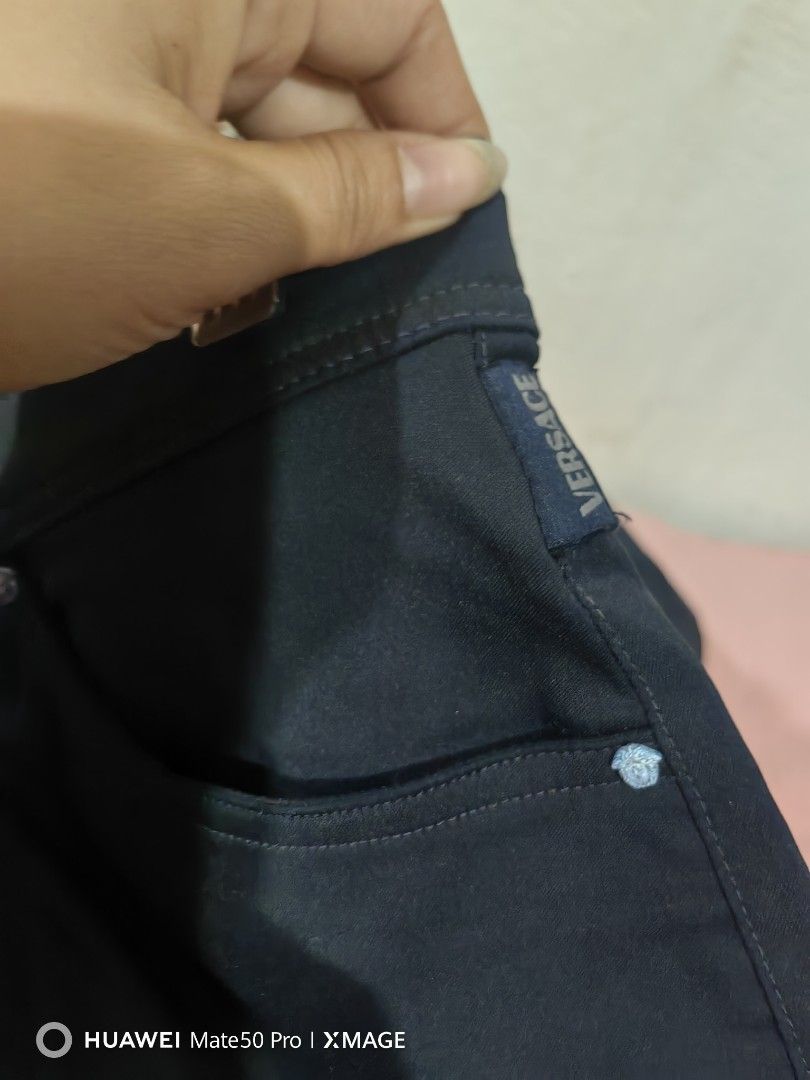 Versace Jeans Couture Dark Wash Jeans (Category: Luxury Apparel) located in Villasis. Submitted by mysticforest.bb2b4b (Listing ID 1447808928, Image 3). Description: - Versace Jeans Couture dark wash jeans - Classic five-pocket style - Button and zip closure - Signature Medusa head detail on coin pocket - Branded leather patch at the back - Straight leg fit - Ideal for casual wear.