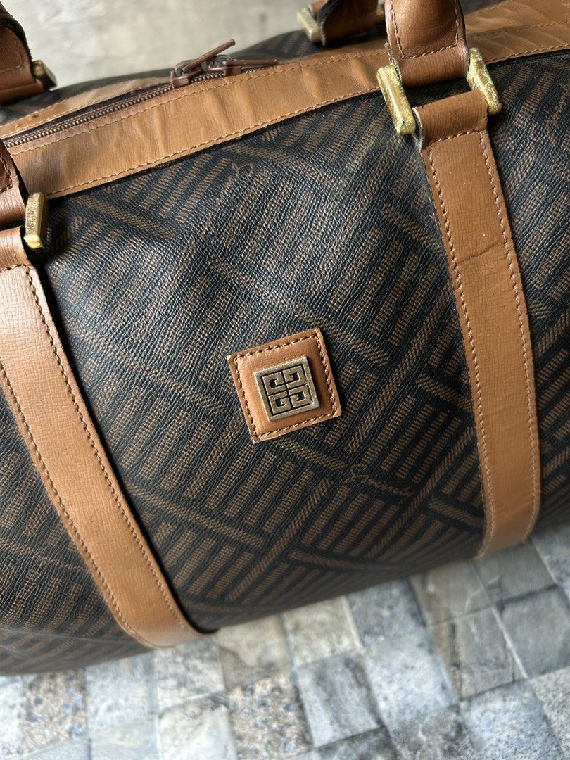 Vintage Givenchy Monogram Canvas Leather Trim Duffle Bag (Category: Luxury Bags & Wallets) located in Quezon City. Submitted by commonwealthpickerph (Listing ID 1447688459, Image 3). Description: Vintage Givenchy Monogram Canvas Leather Trim Duffle Bag - 13.5 width // 8 height // 8.5 length - Iconic monogram print - Brown leather trim and handles - Gold hardware details - Ideal for weekend trips or stylish carry-on - Shows some signs of wear on l