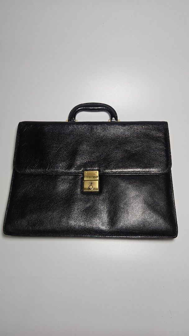 Vintage Lancel Black Leather Briefcase (Category: Luxury Bags & Wallets) located in Alfonso. Submitted by jbcamet (Listing ID 1447813021, Image 1). Description: - Classic black leather briefcase - Secure gold clasp closure - Sturdy top handle - Visible Lancel logo on hardware - Ample interior space for documents and laptop - Ideal for work or business trips.