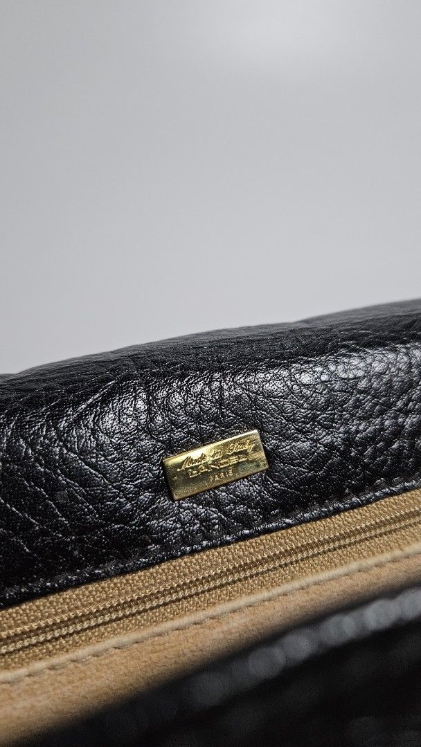 Vintage Lancel Black Leather Briefcase (Category: Luxury Bags & Wallets) located in Alfonso. Submitted by jbcamet (Listing ID 1447813021, Image 2). Description: - Classic black leather briefcase - Secure gold clasp closure - Sturdy top handle - Visible Lancel logo on hardware - Ample interior space for documents and laptop - Ideal for work or business trips.