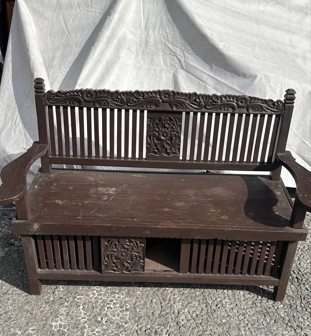 Vintage Molave Galenerra Chair (Category: Chairs) located in Quezon City. Submitted by anjherga27 (Listing ID 1447815742, Image 2). Description: - Vintage wooden bench with intricate carvings - Dark brown wood finish - Slatted seat design - Features a hidden storage compartment - Ideal for entryways or as a decorative accent piece - Sturdy construction.