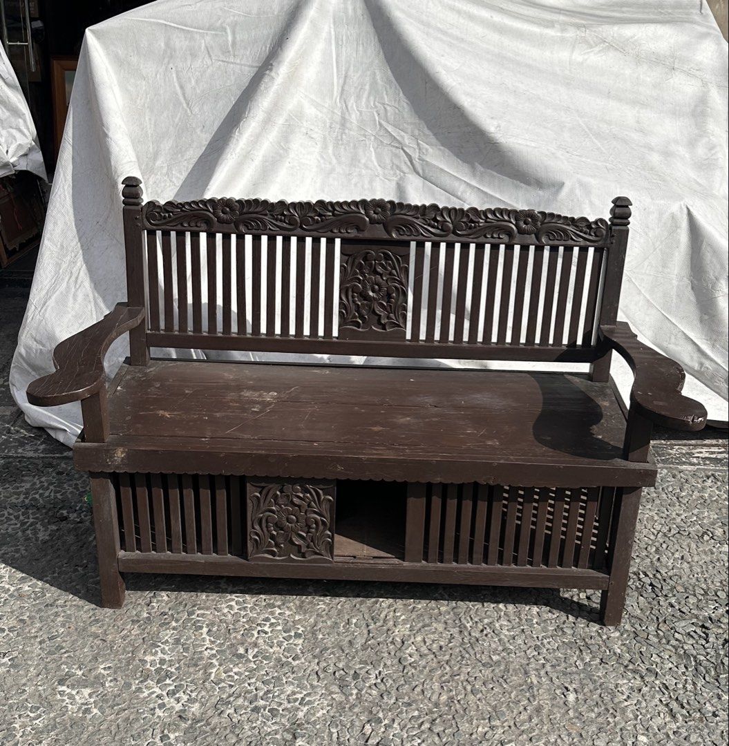 Vintage Molave Galenerra Chair (Category: Chairs) located in Quezon City. Submitted by anjherga27 (Listing ID 1447815742, Image 1). Description: - Vintage wooden bench with intricate carvings - Dark brown wood finish - Slatted seat design - Features a hidden storage compartment - Ideal for entryways or as a decorative accent piece - Sturdy construction.