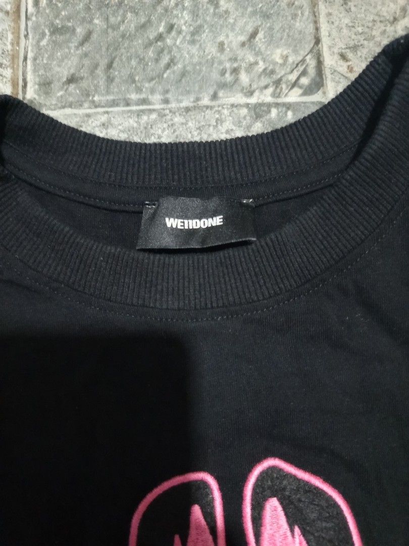 WE11DONE Black Graphic T-Shirt Bunny Logo (Category: Tshirts & Polo Shirts ) located in Ligao. Submitted by john_thrift (Listing ID 1447719082, Image 3). Description: - Black WE11DONE t-shirt -Dime: 19 x 29 - Features a cute pink bunny graphic - 'WE11DONE' text printed below the graphic issue: Cut wash tags 350 shipped.