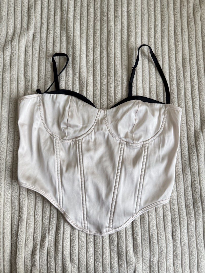 White Satin Corset Top with Black Trim (Category: Others Tops) located in Taguig. Submitted by _anythingpreloved (Listing ID 1447741795, Image 2). Description: - White satin corset top - Black trim detail - Adjustable straps - Boning for structure and support - Back hook and eye closure - Flattering silhouette - Perfect for dressing up or down - Style with jeans or a skirt.
