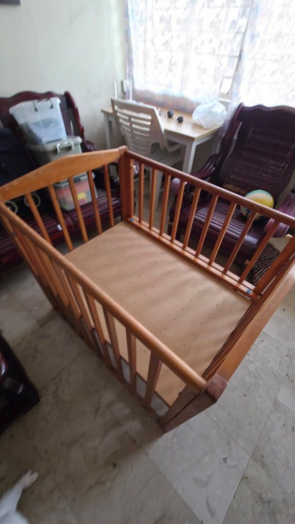 Wooden Baby Crib (Category: Cots & Cribs) located in Quezon City. Submitted by fabfindsph (Listing ID 1447795734, Image 2). Description: - Solid wood baby crib from Japan - Natural wood finish - 27x37x35in - Good Condition - Minor Scratch - Sturdy construction with slatted sides - Solid panel base - Ready for a new home - Perfect for a nursery.