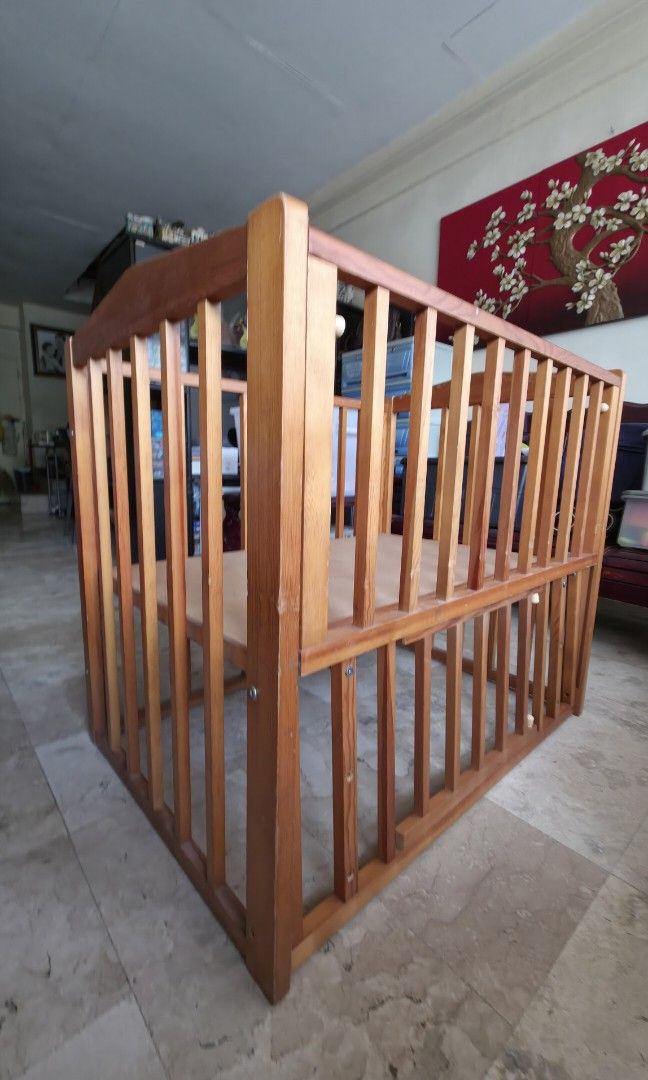Wooden Baby Crib (Category: Cots & Cribs) located in Quezon City. Submitted by fabfindsph (Listing ID 1447795734, Image 3). Description: - Solid wood baby crib from Japan - Natural wood finish - 27x37x35in - Good Condition - Minor Scratch - Sturdy construction with slatted sides - Solid panel base - Ready for a new home - Perfect for a nursery.