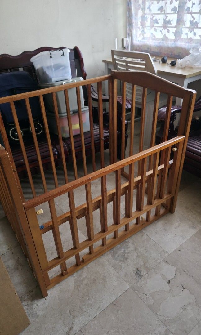 Wooden Baby Crib (Category: Cots & Cribs) located in Quezon City. Submitted by fabfindsph (Listing ID 1447795734, Image 1). Description: - Solid wood baby crib from Japan - Natural wood finish - 27x37x35in - Good Condition - Minor Scratch - Sturdy construction with slatted sides - Solid panel base - Ready for a new home - Perfect for a nursery.
