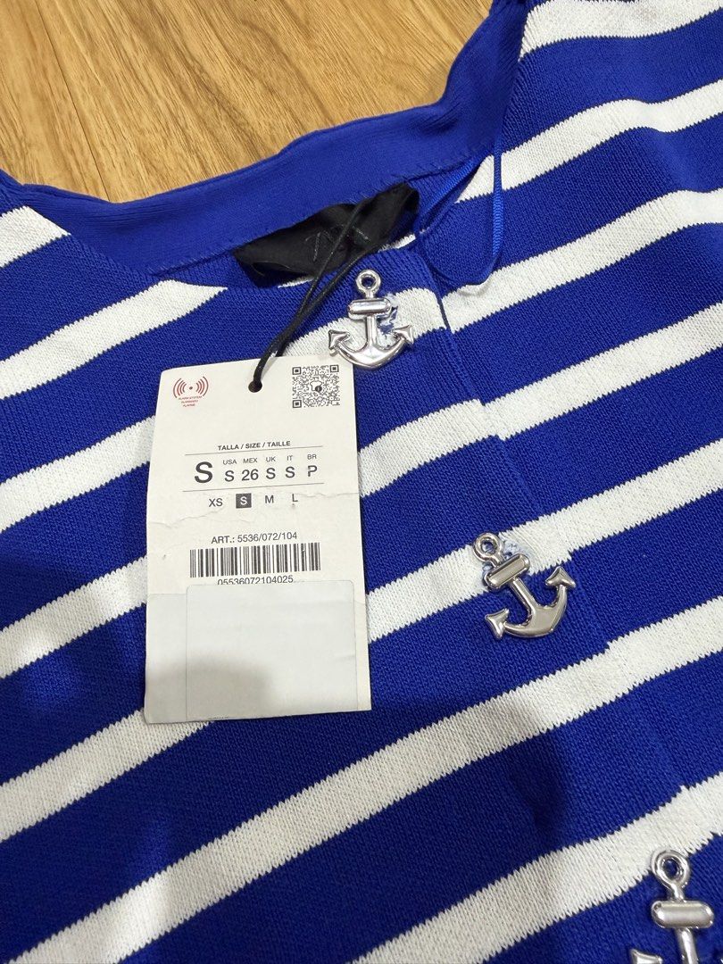 Zara Striped Anchor Button Cardigan Top Size S (Category: Longsleeves) located in Caloocan City. Submitted by MSCloset_ (Listing ID 1447795404, Image 2). Description: - Blue and white striped short sleeve cardigan - Features stylish silver anchor buttons down the front - Brand new with tags attached - Estimated size: S - Perfect for a chic nautical outfit.