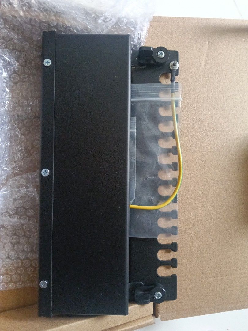 12-Port Network Patch Panel (Category: Networking) located in Singapore. Submitted by neighbourhoodelectrician (Listing ID 1447912607, Image 1). Description: - 12-port patch panel - Black casing with numbered ports 1-12 - Includes bubble wrap - Ideal for organizing network cables - Ready for pickup.