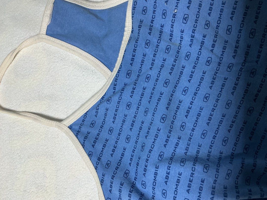 Abercrombie & Fitch Tank Top (Category: Sleeveless) located in Makati City. Submitted by studentista (Listing ID 1448066477, Image 3). Description: - Blue Abercrombie & Fitch tank top - All-over navy logo print - Racerback style with white trim - Soft and stretchy material for comfort - Versatile for casual wear or layering - Easily pairs with jeans or shorts.
