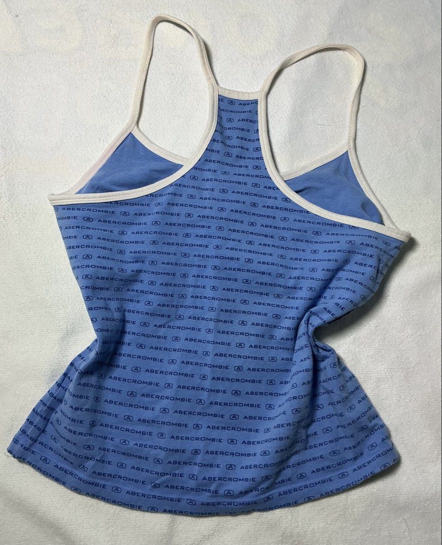 Abercrombie & Fitch Tank Top (Category: Sleeveless) located in Makati City. Submitted by studentista (Listing ID 1448066477, Image 2). Description: - Blue Abercrombie & Fitch tank top - All-over navy logo print - Racerback style with white trim - Soft and stretchy material for comfort - Versatile for casual wear or layering - Easily pairs with jeans or shorts.