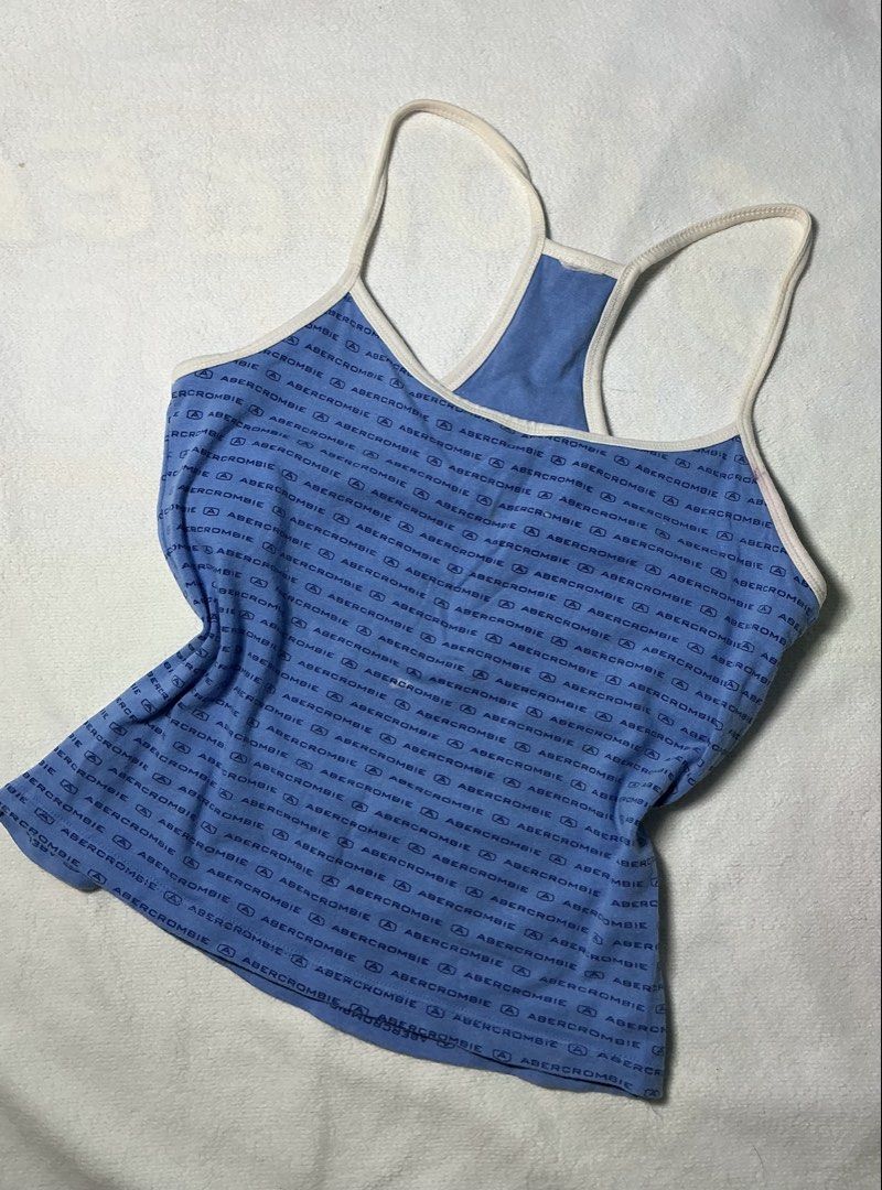 Abercrombie & Fitch Tank Top (Category: Sleeveless) located in Makati City. Submitted by studentista (Listing ID 1448066477, Image 1). Description: - Blue Abercrombie & Fitch tank top - All-over navy logo print - Racerback style with white trim - Soft and stretchy material for comfort - Versatile for casual wear or layering - Easily pairs with jeans or shorts.