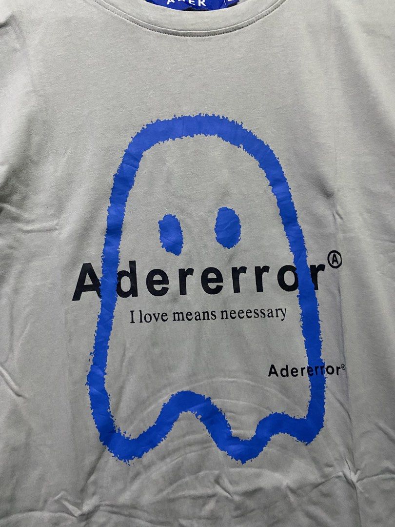 Adererror Ghost Print T-Shirt Grey (Category: Tshirts & Polo Shirts ) located in Manila. Submitted by hell_market (Listing ID 1448035196, Image 2). Description: - Grey Adererror T-Shirt - 100% Cotton - Features blue ghost graphic - Text: 'I love means neeessary' - Adererror logo detail - From the FW20 Fall Winter Collection - Care Instructions: Dry clean, do not bleach, hand wash, no twisting, dry flat, iron medium.