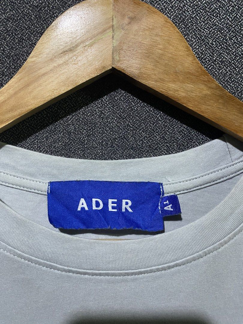 Adererror Ghost Print T-Shirt Grey (Category: Tshirts & Polo Shirts ) located in Manila. Submitted by hell_market (Listing ID 1448035196, Image 3). Description: - Grey Adererror T-Shirt - 100% Cotton - Features blue ghost graphic - Text: 'I love means neeessary' - Adererror logo detail - From the FW20 Fall Winter Collection - Care Instructions: Dry clean, do not bleach, hand wash, no twisting, dry flat, iron medium.