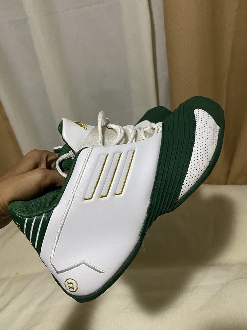 Adidas T-Mac 1" x lebron james (Category: Sneakers) located in Barobo. Submitted by sonogonggr22560 (Listing ID 1448030440, Image 3). Description: - Adidas T-Mac 3 basketball shoes - Color: White with green and gold accents - Iconic three stripes design - '23' detail on the heel - Perfect for collectors or players.